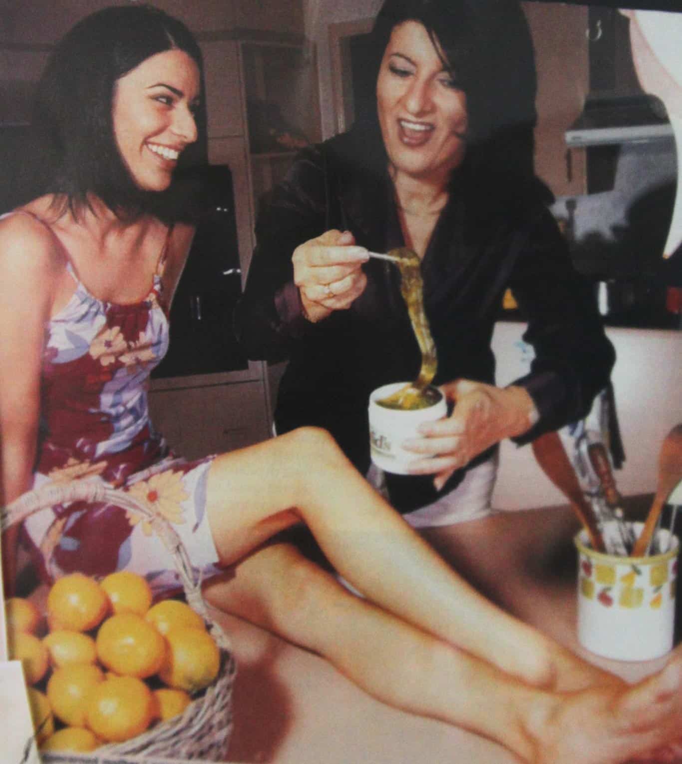 Aged photograph of Sue Ismiel applying Nad's Gel to Nadine Ismiel's leg